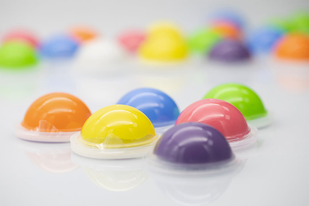 Professional Dental Home Impression Kit featuring colorful dome-shaped putty containers arranged in rows, showcasing vibrant yellow, blue, pink, and purple catalyst materials for precise dental impressions at home