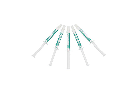 Five dental syringes with turquoise-colored try-in gel containing TopCEM Try-in Veneer Try-in Gel, arranged in a fan pattern against white background, featuring transparent dispensing tips for precise application