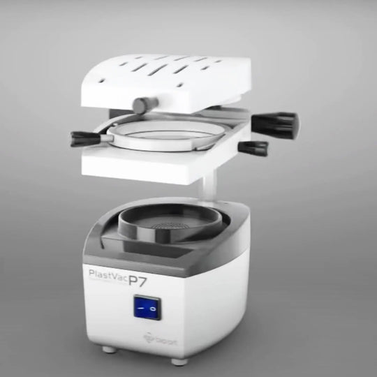 BIOART Dental Vacuum Forming Machine Laboratory Heat Molding Equipment PLASTVAC-P7 with open heating element, circular mold platform, and compact base unit featuring power switch and controls for dental thermoforming applications.