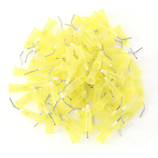 Dental Pre Bent Needle Tips: Pile of yellow plastic tips with metal needles for luer lock syringes. 5 bags, 9 models, 100pcs/bag. Various sizes from 18G to 25G. Single-use professional dental equipment. Sterile, disposable, and precisely angled for dental procedures.