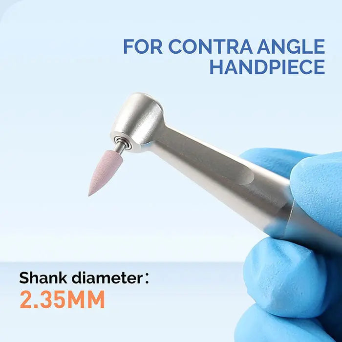 Dental Silicone Polishing Kit contra angle handpiece with pink polishing tip, 2.35MM shank diameter, for composite, natural teeth, and porcelain finishing. Blue-gloved hand holding the device against light blue background.