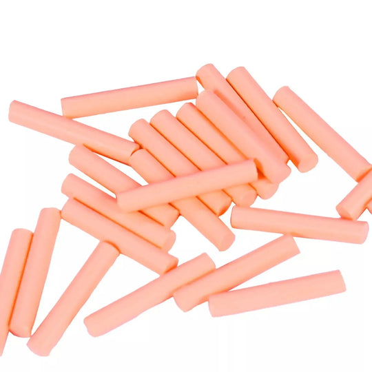 Dental Gutta Percha Obturator for Obturation Gun Pen Soft Type 100pcs/Bottle: Pink cylindrical dental gutta percha sticks scattered on white background, used for root canal filling in dental procedures