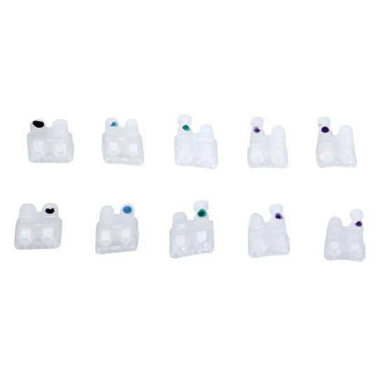 Ceramic Brackets Roth .018 Hooks 345 20pcs/Box: Set of 10 white ceramic orthodontic brackets with colored dots, arranged in two rows. Brackets feature a smooth, low-profile design for comfortable dental alignment and rapid leveling.