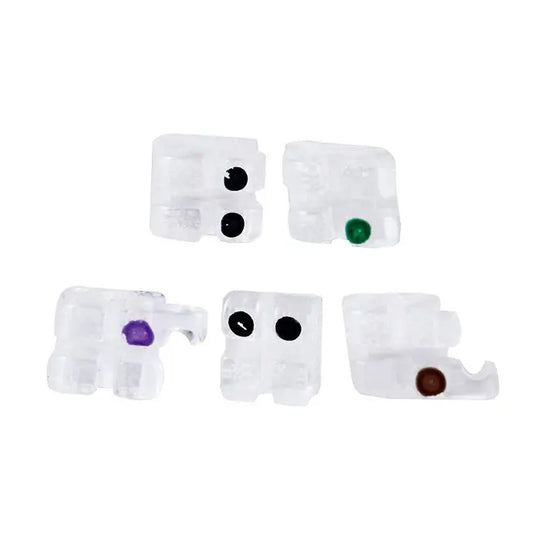 Close-up of five Dental Ceramic Bracket Monocrystalline Sapphire Roth 0.022 brackets with hooks on 3, showing transparent crystal-clear material and color-coded dots for easy identification. Brackets display mini size, low profile, and smooth surface design for dental orthodontic use.