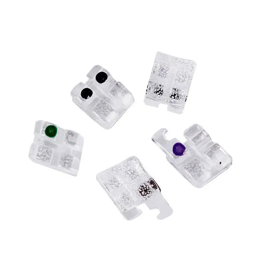 Dental Ceramic Bracket Monocrystalline Sapphire Roth 0.022 Hooks on 3 20pcs/Box: Five transparent ceramic orthodontic brackets with color-coded dots for identification, showcasing mini size, low profile design, and smooth surface for dental applications.