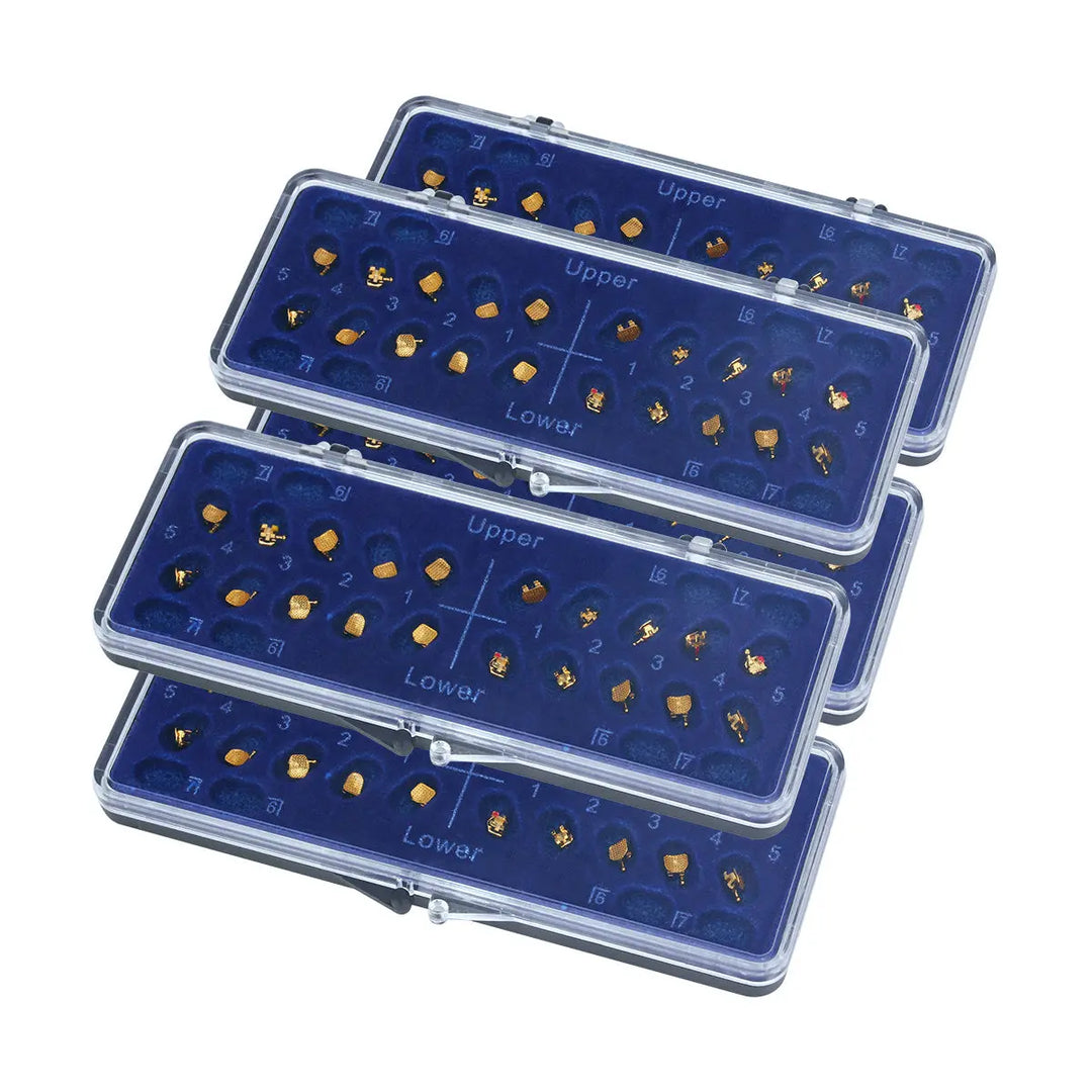 Dental Metal Brackets Mini MBT 0.022 Hooks on 345 Gold Color 20pcs/Box displayed in four transparent plastic cases with blue inserts. Each case contains multiple small golden-colored dental brackets arranged in rows, clearly labeled for upper and lower teeth placement.