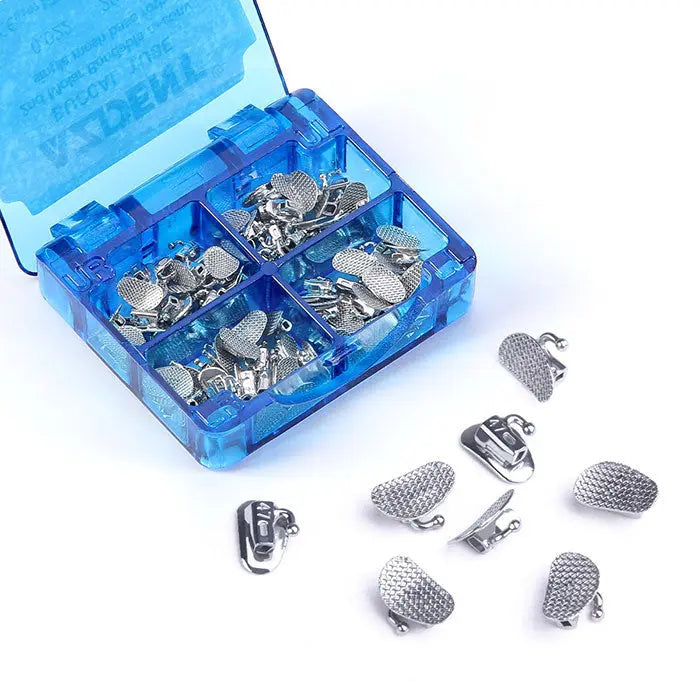 Buccal Tube 2nd Molar Bondable Split Non-Convertible Roth 0.022 20Sets/Box displayed in a blue plastic organizer case. Multiple small silver orthodontic components visible, including mesh-patterned attachments and tube-like structures, with some pieces scattered outside the case for detail.