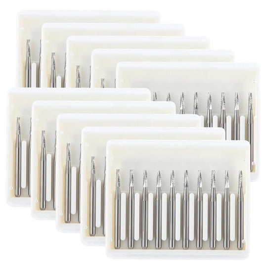 Dental Carbide Bur FG #701 Flat End Taper Fissure Crosscut 10pcs/Box: Multiple sets of silver dental burs with tapered, flat-end design arranged in white plastic organizers. High-speed handpiece compatible, tungsten carbide construction for durable cutting performance.