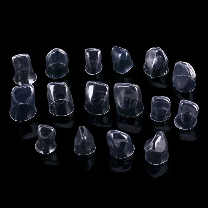 Dental Anterior Transparent Crowns for Adult № 1.910 64Pcs/Box: Various sizes of clear, anatomically shaped dental crowns for incisors and canines displayed on a black background, showcasing their transparent material and contoured design for optimal fitting and natural appearance.