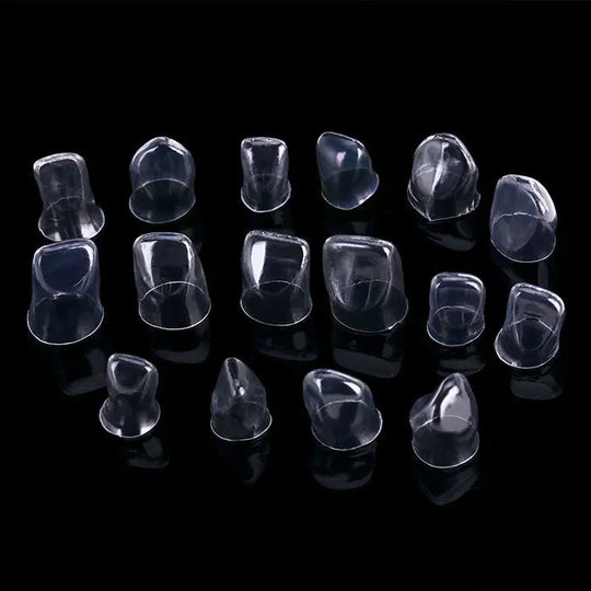 Dental Anterior Transparent Crowns for Adult № 1.910 64Pcs/Box: Various sizes of clear, anatomically shaped dental crowns for incisors and canines displayed on a black background, showcasing their transparent material and contoured design for optimal fitting and natural appearance.