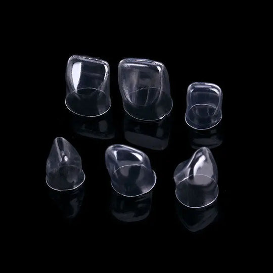 Dental Anterior Transparent Crowns for Aldult № 1.910 64Pcs/Box: Six clear plastic dental crowns in various sizes for incisors and canines, showcasing anatomical contours and thin walls for optimal fitting and natural appearance