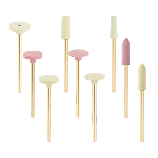 Dental Zirconia Grinding and Polishing Kit featuring 9 ceramic and rubber diamond polishers with various shapes and sizes. Pink and cream-colored polishing heads on gold-toned metal shafts, arranged neatly in a row against a white background.