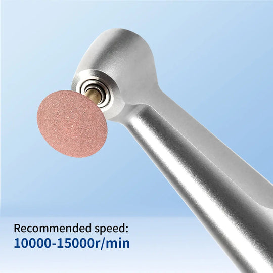 Dental Zirconia Grinding and Polishing Kit with ceramic rubber diamond polisher attached to contra angle handpiece. Pink polishing disc visible. Recommended speed 10000-15000r/min displayed. For efficient zirconia restoration in dental procedures.