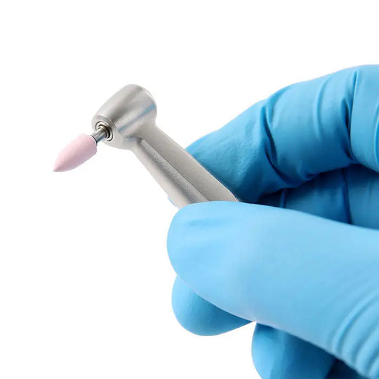 Dental Silicone Polishing RA 2.35mm Coarse Medium Fine For Contra Angle Handpiece held by gloved hand, showcasing pink polishing tip attached to metal shaft, demonstrating dental tool for composite restoration finishing and polishing