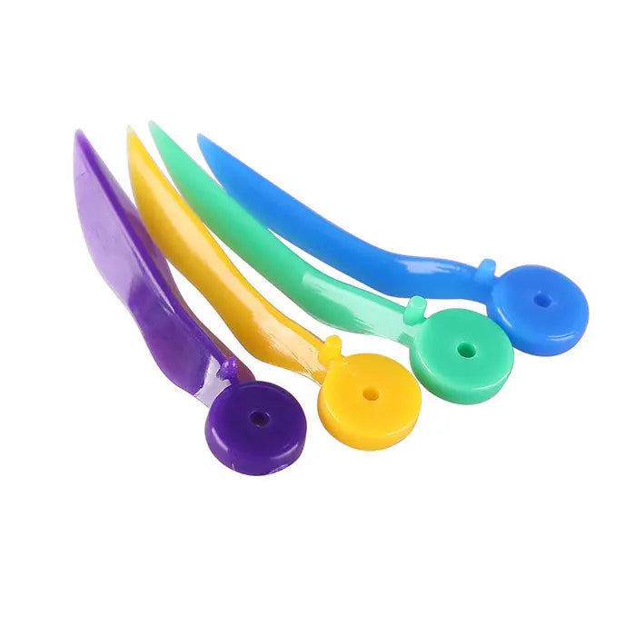 Dental Disposable Wedges With Hole Plastic Tooth Gap Wedge 4 Sizes 100pcs/Box - Colorful plastic dental wedges in purple, yellow, green, and blue, with curved shapes and circular holes at one end, designed for various interdental spaces and easy handling during dental procedures.