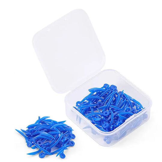 Dental Disposable Wedges With Hole Plastic Tooth Gap Wedge 4 Sizes 100pcs/Box: Blue plastic dental wedges in transparent storage box, with some wedges scattered outside. Wedges feature curved design and circular holes for easy handling.