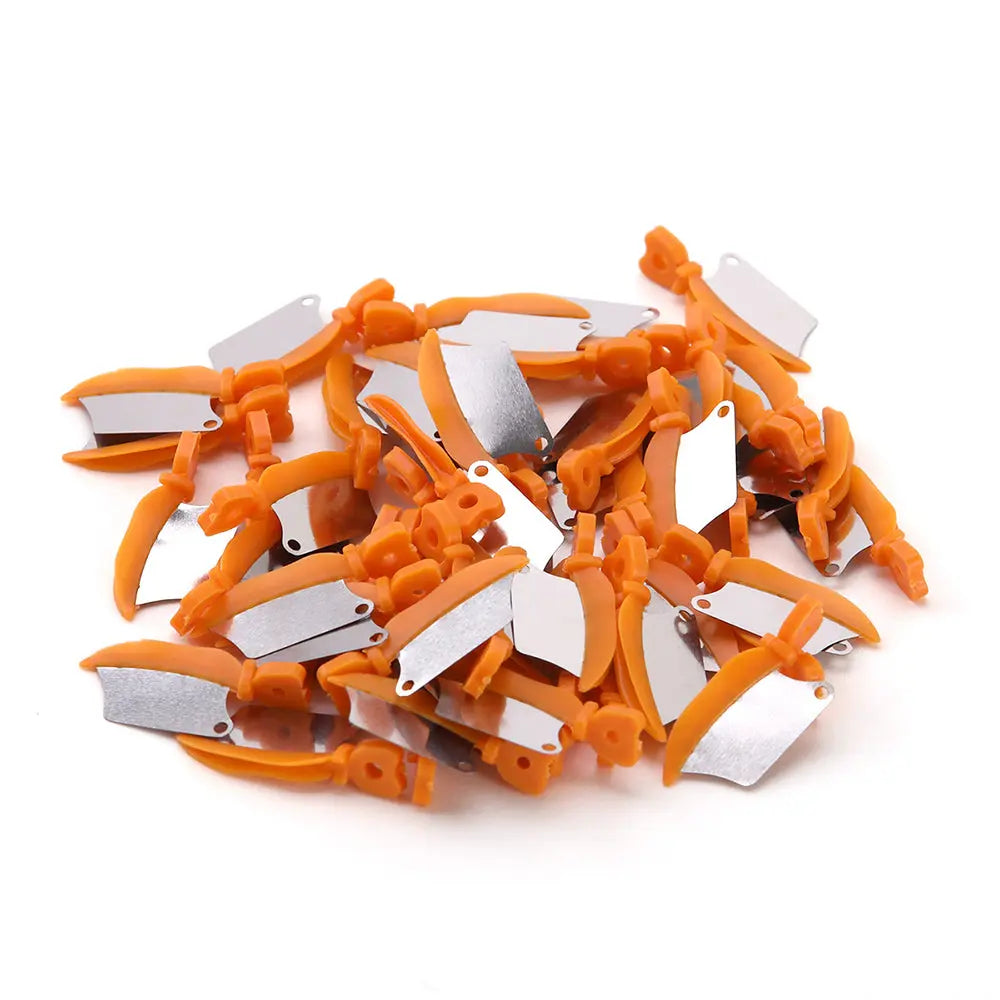 Dental Prime Teeth Interproximal Plastic Wedges with Protection Dental Steel Matrix, medium orange, 50 per box. Close-up of orange plastic wedges with attached metal matrices scattered on white background, showing product detail and quantity.