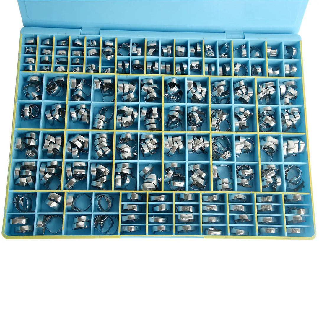 Dental Buccal Tubes Band Roth .022 1st Molar Single Welded & Conv 85sets/Box displayed in a blue compartmentalized case. Multiple stainless steel orthodontic components organized neatly in individual sections, showcasing the variety and quantity of dental buccal tubes included in the product.