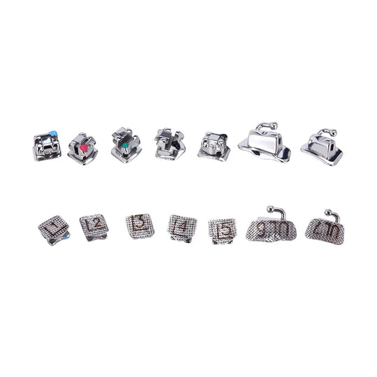 Dental Self-Ligating Metal Brackets Roth/MBT .022 set displayed in two rows, showing various bracket designs and sizes for different teeth positions, including hooks and buccal tubes, with numbered bases for easy identification and placement in orthodontic treatments.