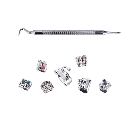 Dental Self-Ligating Metal Brackets set with hooks and tools, including a metal dental instrument and various small metal brackets with different designs and colors, arranged on a white background for Roth/MBT .022 orthodontic treatment