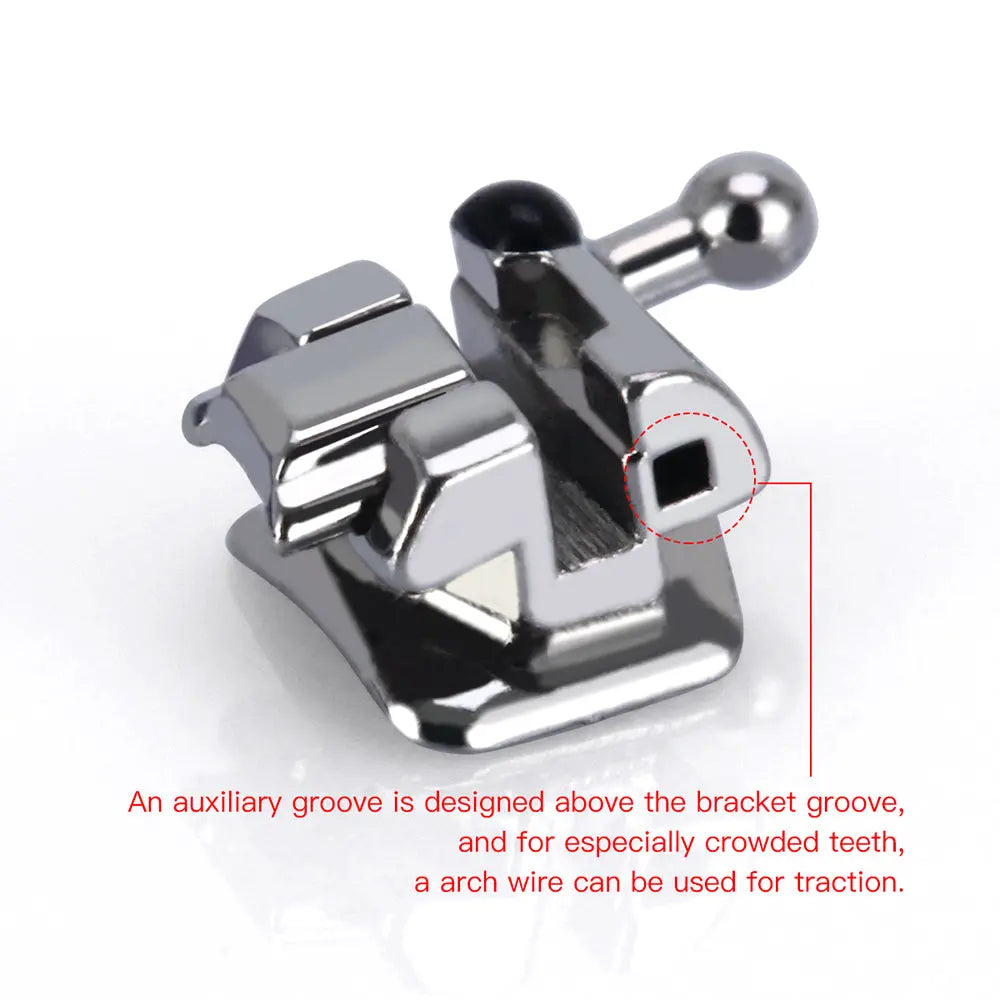 Close-up of a Dental Self-Ligating Bracket from the "Dental Self-Ligating Brackets Passive Roth/MBT .022 Hooks On 345 With Buccal Tube 28pcs/Box" set, showing its metallic structure with an auxiliary groove above the main bracket groove for arch wire traction in crowded teeth.