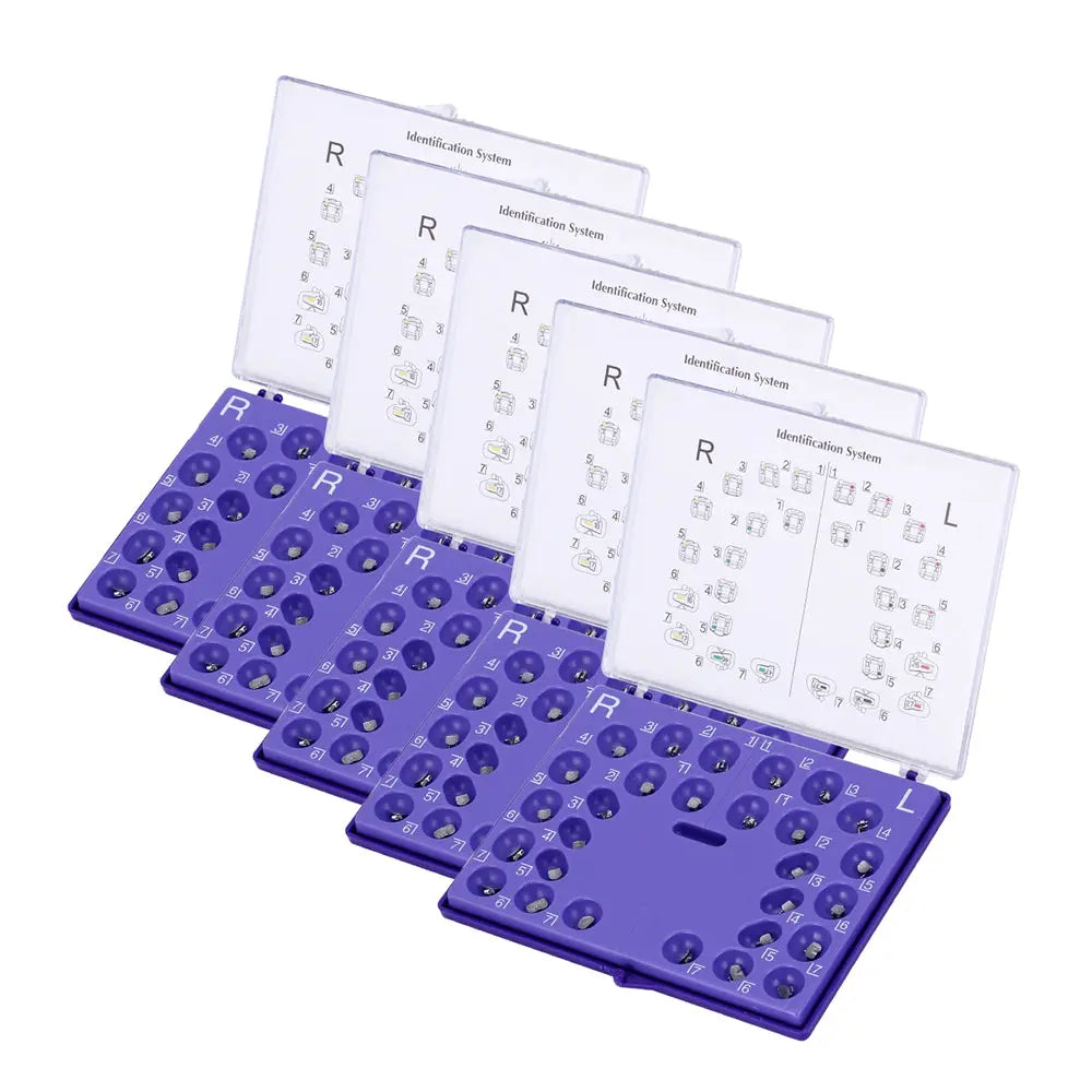 Dental Self-Ligating Brackets Passive Roth/MBT .022 displayed in five purple plastic trays with clear lids showing bracket positioning charts. Each tray contains 28 small metal orthodontic brackets arranged in rows, designed for efficient and comfortable dental treatment.