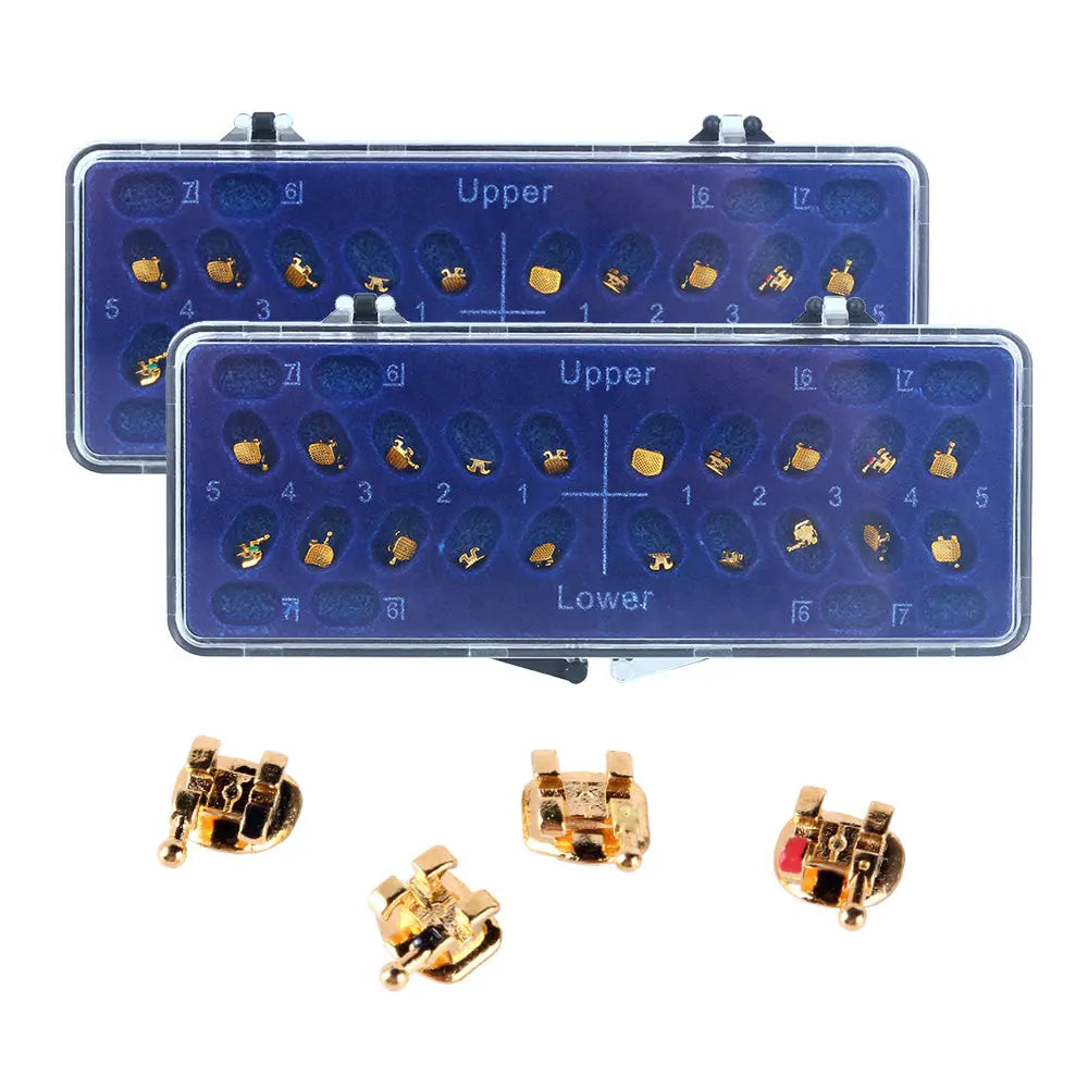 Dental Metal Brackets Mini Roth/MBT 0.022 Hooks on 345 Gold Color 20pcs/Box displayed in blue cases with numbered slots for upper and lower teeth. Gold-colored brackets shown separately below, highlighting the product's appearance and organization.