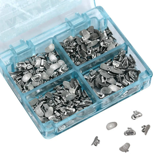 Buccal Tube 2nd Molar Bondable Split Non-Convertible Roth 0.018 50Sets/Bx displayed in a blue plastic organizer box with four compartments filled with small silver orthodontic components. Close-up view of individual pieces scattered outside the box.