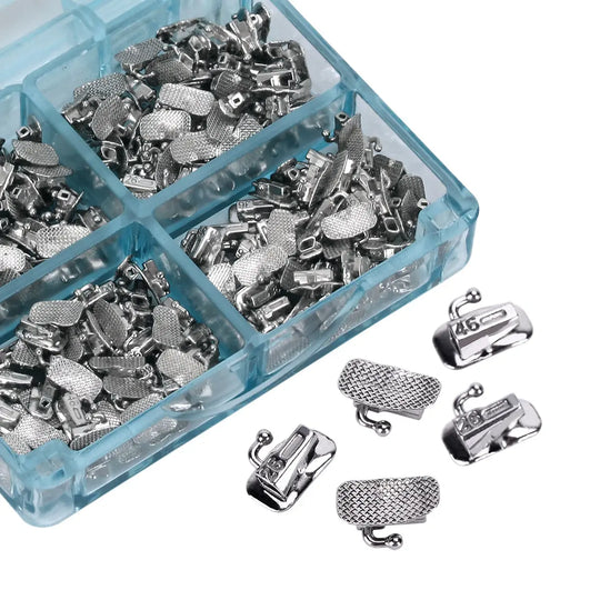 Buccal Tube 1st Molar Bondable Split Non-Convertible Roth 0.018 50Sets/Bx in blue plastic organizer. Multiple compartments filled with silver-colored orthodontic components, including tubes and mesh bases. Close-up view of individual pieces outside the organizer.