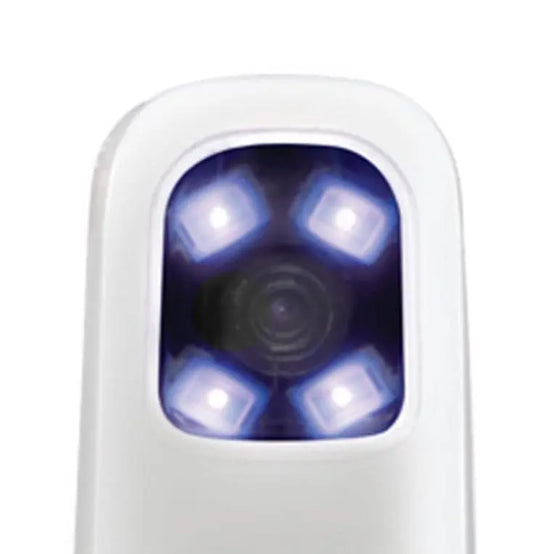 CamX Spectra Caries Detection Aid device close-up showing white handpiece with illuminated violet LED lights surrounding a central camera lens, highlighting advanced dental imaging technology for early cavity detection