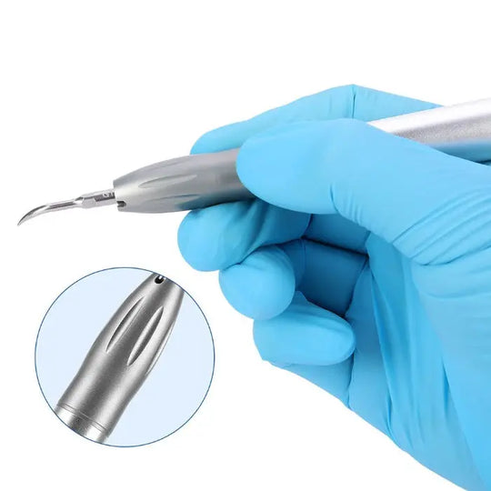 Dental Air Scaler Handpiece Super Sonic Scaling Handle 4 Holes With 3 Scaler Tips in use, showing gloved hand holding silver metal handpiece with curved tip, close-up of scaler body and tip design