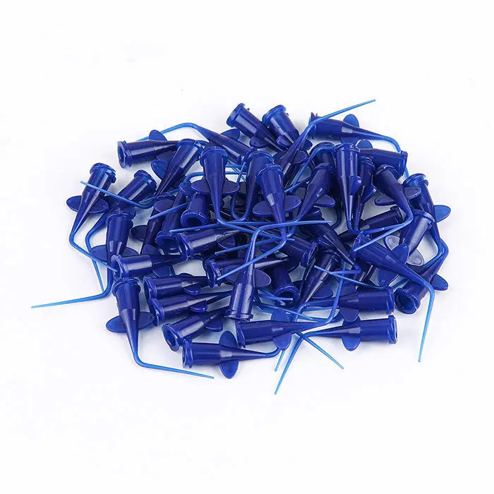 Dental Disposable Endo Irrigation Syringe 50 Pcs And Tip 50 Pcs: Close-up of blue plastic irrigation tips and syringes for dental endodontic procedures, scattered in a pile showing flexibility and small diameter for precise canal maneuverability and patient comfort