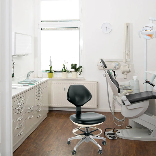 Modern dental office with dental chair, black adjustable doctor stool, equipment, and white cabinets. Bright space with window. Dental Doctor Stool With Adjustable Seat And Backrest 360-Degree Fully Rotated visible in foreground.