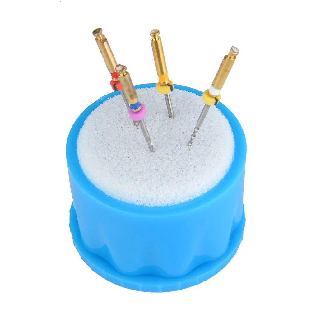 Dental Endodontic Sponge Endo Clean Stand Oval Insert Refill: Blue circular base with white sponge top, holding three dental tools with gold handles and silver tips, demonstrating product functionality and design for endodontic procedures