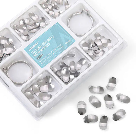 Dental Matrix Sectional Silicone Wedges Set: Organized plastic case containing metal matrices in various sizes, two metal rings, and scattered metal pieces. Blue label visible. Professional dental tools for tooth restoration procedures.