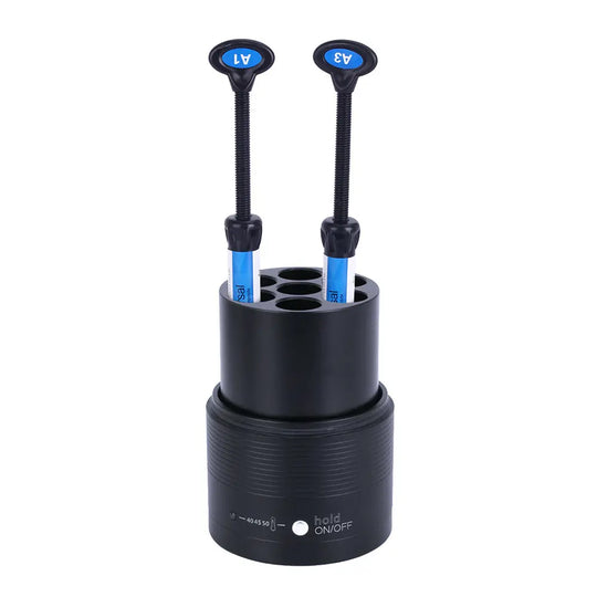 Dental Resin Composite Softener Heater Material Warmer 40℃-50℃ with black cylindrical base and two blue-tipped dental tools inserted into storage holes, designed for heating composite resin to improve flow and adhesive properties