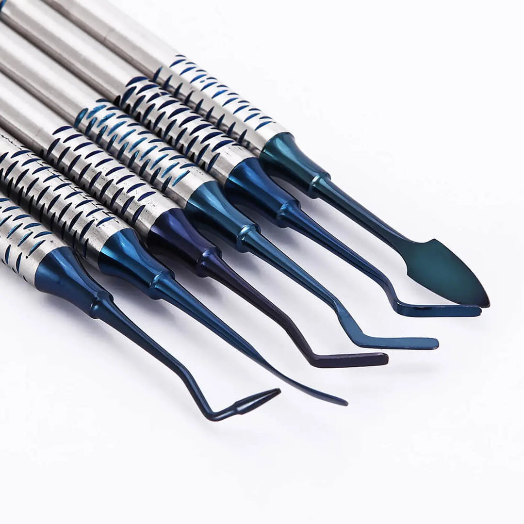 Dental Tools Composite Resin Filling Spatula set with titanium-plated blue heads. Six precision instruments for smooth amalgam restorations, featuring stainless steel handles and various shaped tips for optimal flexibility and aesthetic results in dental procedures.