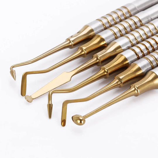 Dental Tools Composite Resin Filling Spatula Titanium Plated Head Filler Gold set of 6 professional instruments with gold-colored tips and silver handles displayed in a row, showcasing various shapes for precise dental procedures and composite resin applications