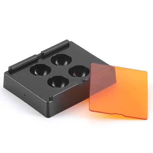 Dental Veneer Storage Box with 4 holes for teeth patches, featuring a black plastic base and orange tinted protective cover. Designed for secure storage of dental veneers, dentures, and retainers with light-shading capabilities.