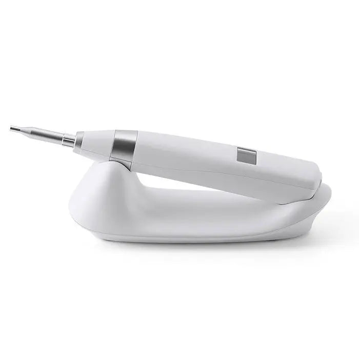 Dental Implant Stability Device Measuring: Handheld white and silver dental instrument with a pointed tip, resting on a curved white base, used for assessing implant stability through tapping method.