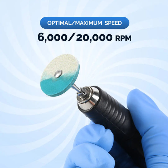 Dental Rubber Diamond Polisher Wheel Disc for porcelain shown in use, with blue gloved hand holding dental tool. Speed specifications of 6,000/20,000 RPM displayed. Teal polishing disc attached to black handpiece against light background.