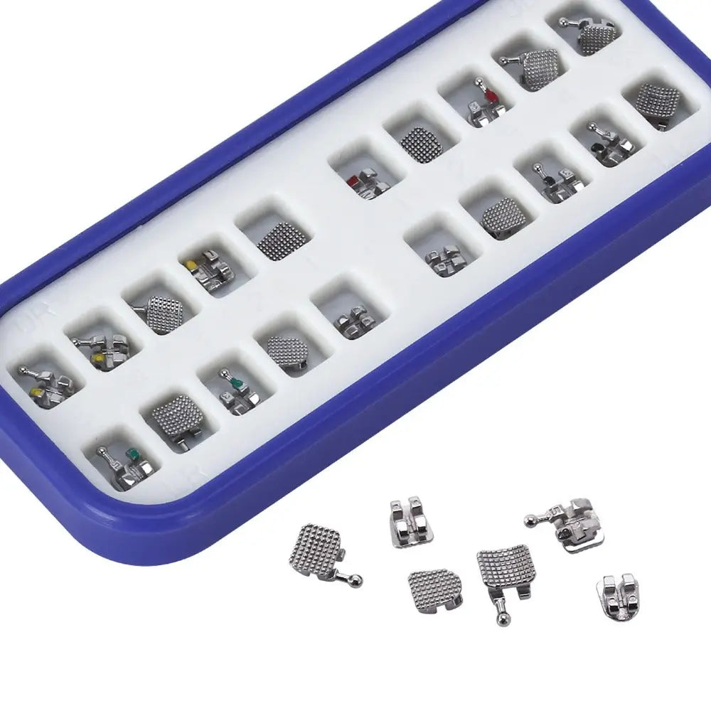 Dental Metal Brackets MIM Monoblock Mini MBT 0.022 Hooks on 345 20pcs/Kit displayed in blue tray with individual compartments. Various sizes and styles of orthodontic brackets visible, showcasing product variety and organized packaging for dental professionals.