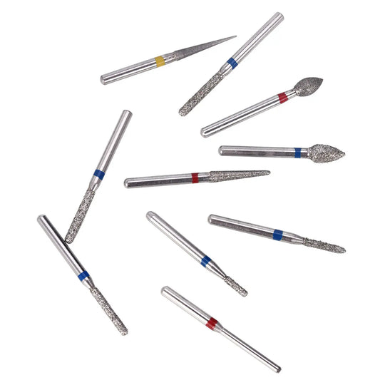 Dental Diamond Bur FG-112 Crown Preparation Anterior Teeth Kit 10pcs/Kit displayed as various silver dental burs with diamond-coated tips and color-coded bands, arranged in a scattered pattern on a white background, showcasing different shapes for specific dental procedures.