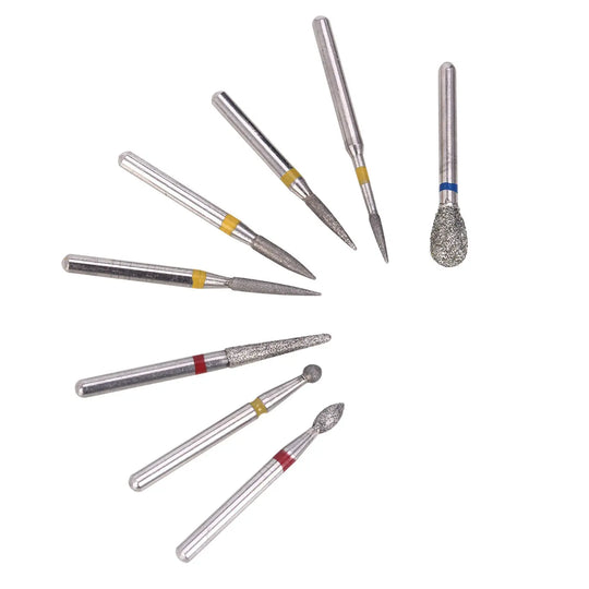 Dental Diamond Bur FG-114 Composite Resin Kit 8pcs/Kit: Assorted dental diamond burs with different shapes and sizes, including cylindrical, flame, and round-end types, designed for precision dental work on composite resins. Metal shafts with diamond-coated tips and color-coded bands.