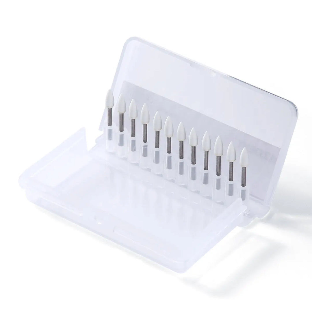 Dental Polishing FG Burs Flame Shape White Stone 12pcs/Kit displayed in a clear plastic case, showing 12 white flame-shaped dental burs neatly arranged in a row, used for dental polishing procedures