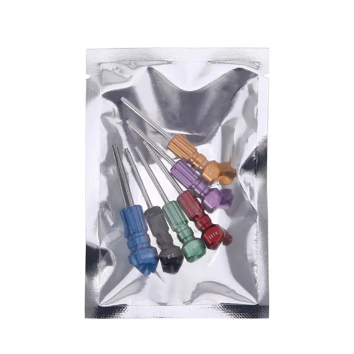 Dental Implant Screw Driver Manual Use 6pcs/Kit displayed in a clear plastic package. Six colorful drivers with different tip sizes and shapes, including blue, green, red, purple, and orange handles, arranged neatly on a reflective silver surface.