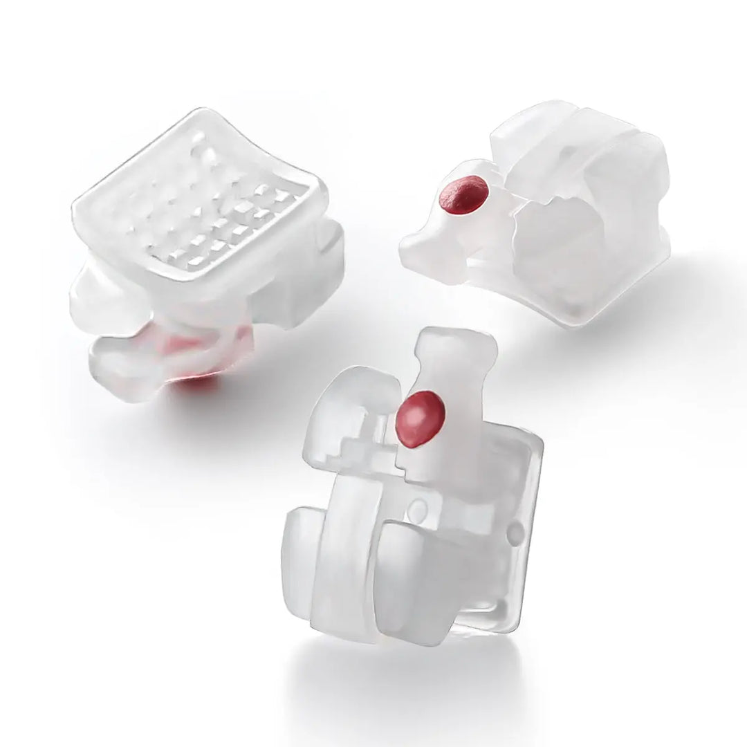 Dental Self-ligating Ceramic Brackets Clear Roth/MBT 0.022 with hook 3,4,5 - Three translucent white orthodontic brackets with red accents, showcasing smooth edges and innovative self-ligating design for comfort and efficient tooth movement.