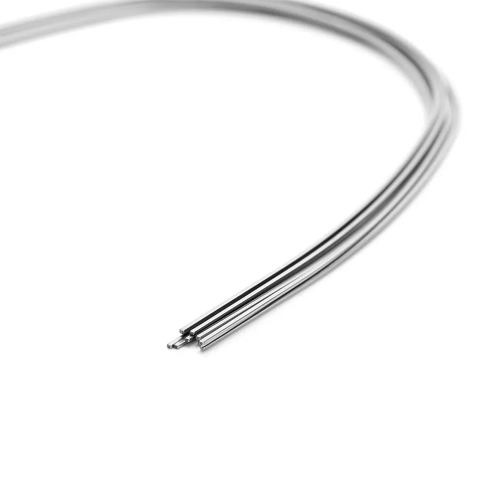 Archwire Niti Super Elastic Ovoid Form Rectangular Ovoid 0.016 x 0.025 Lower 10pcs/Pack: Close-up of curved, shiny metallic orthodontic wire on white background, showcasing its flexibility and smooth finish for dental applications.