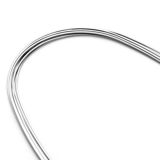 Archwire Niti Super Elastic Ovoid Form Rectangular Ovoid 0.016 x 0.025 Lower 10pcs/Pack - Close-up of curved, shiny metal orthodontic wire against white background, showcasing its smooth surface and flexible ovoid shape for lower teeth alignment