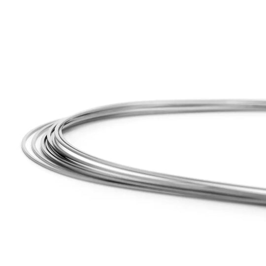 Coiled silver-colored Archwire Niti Super Elastic Ovoid Rectangular 0.018 x 0.018 Lower dental orthodontic wire, showcasing its flexibility and smooth finish for efficient tooth movement and patient comfort